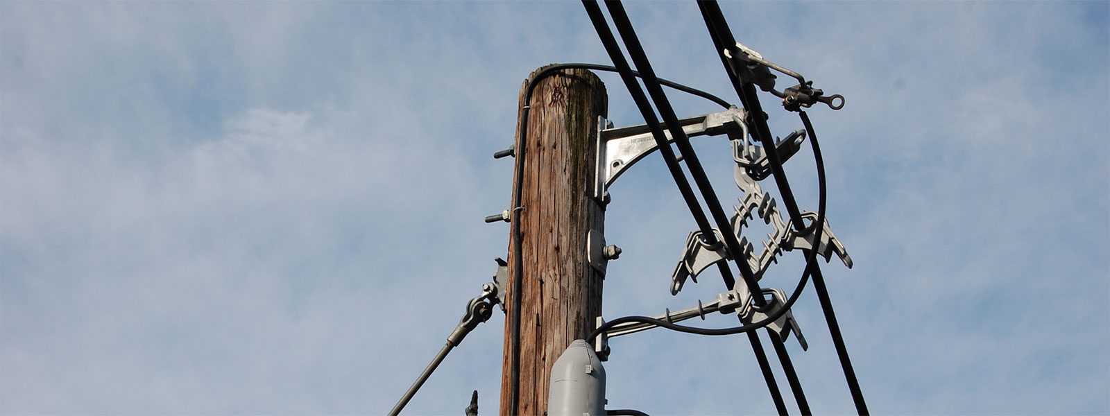 Covered tap wire running from a spacer cable system