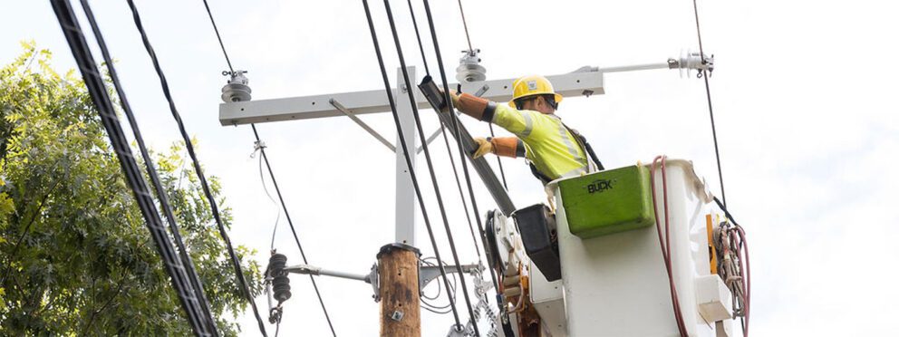 Lineman installing line duc