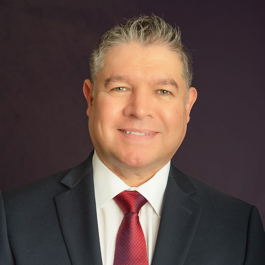 Headshot of smiling male in a suit