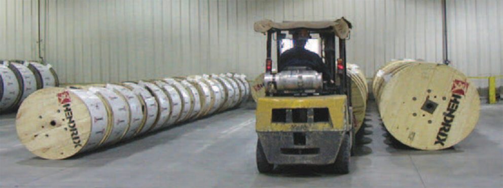 Reels of Hendrix cable being moved by forklift