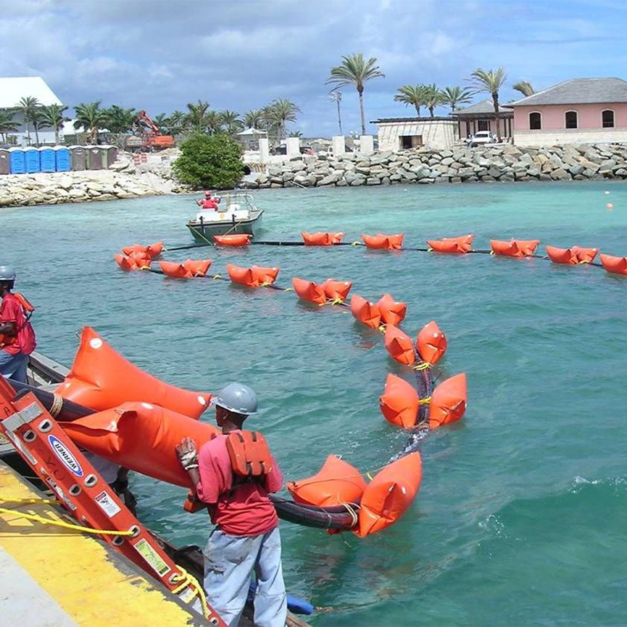 Underground cable floating at top of ocean with orange floats