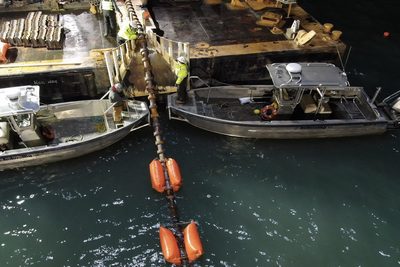 Subsea cable install of conductor running off a boat into ocean