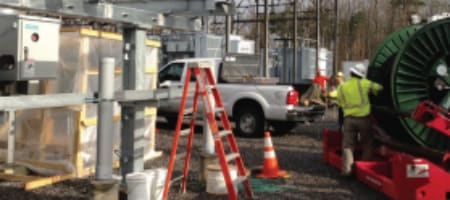 Worker On A Job Site In Front Of Reel