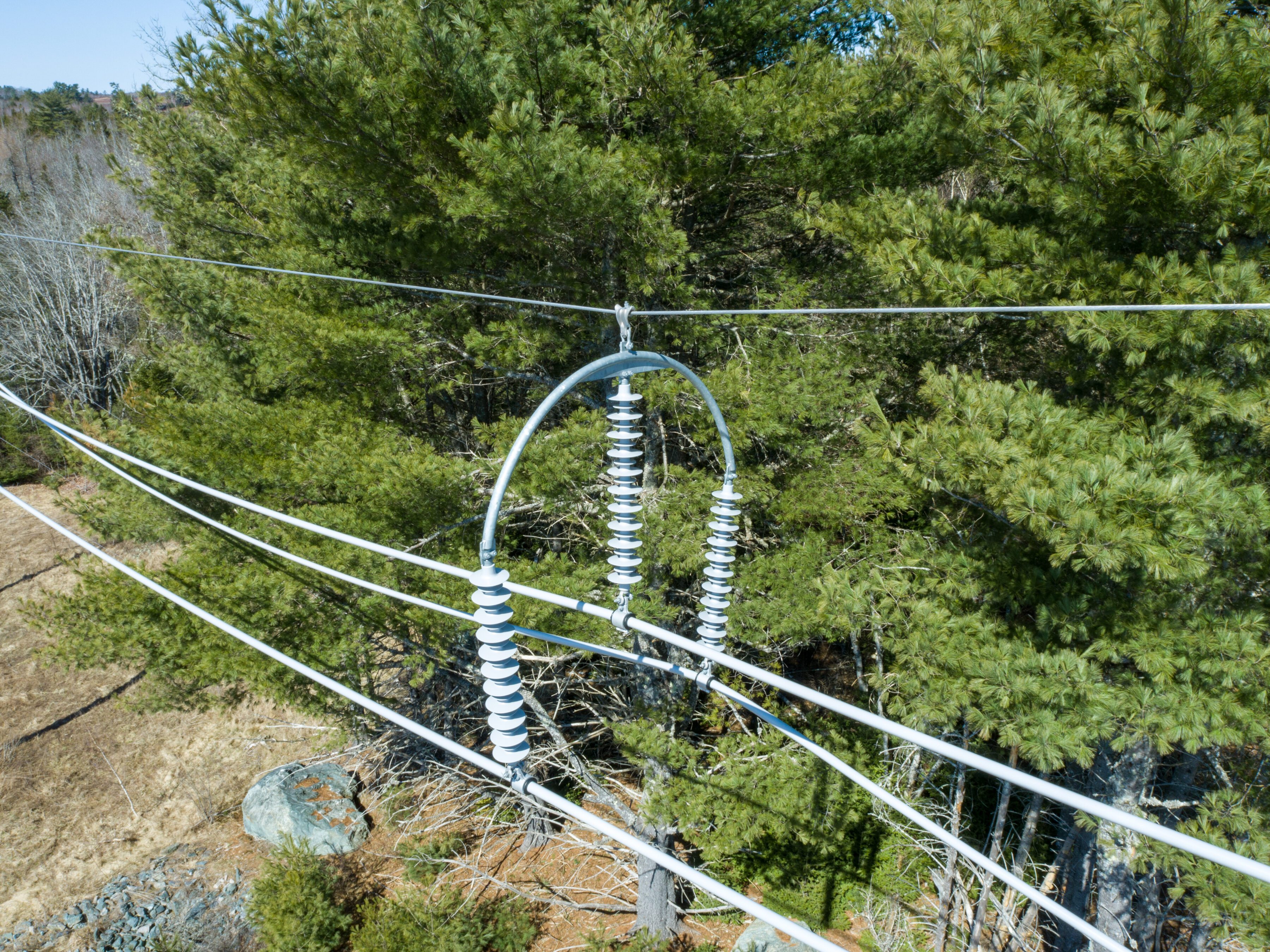 115kV spacer mid-span in a treed area